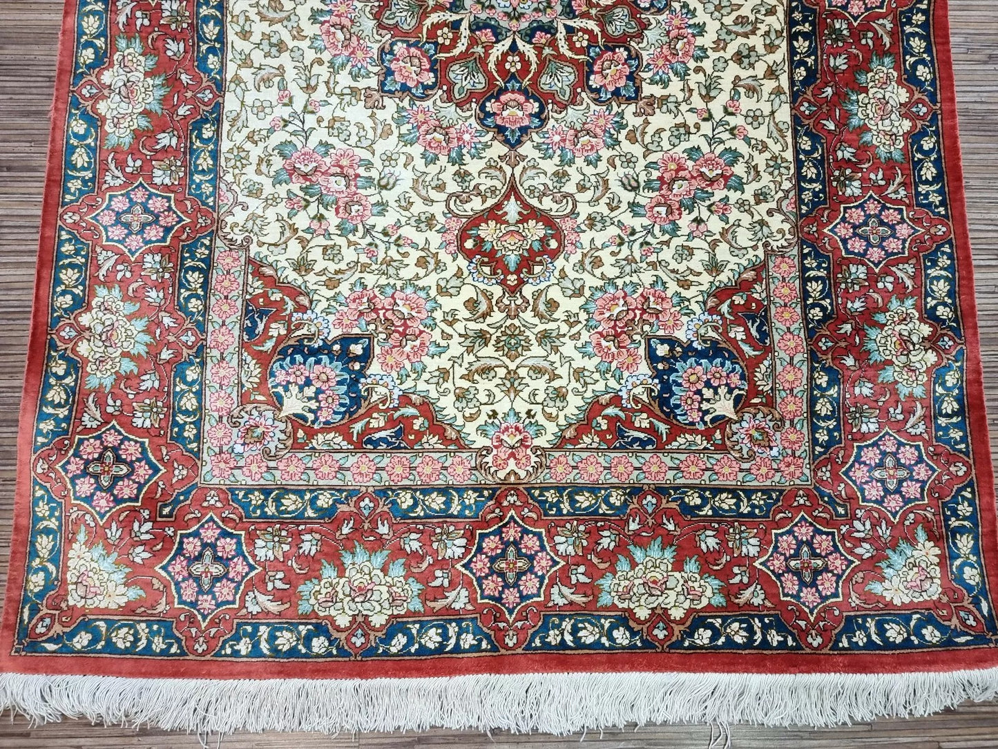 Luxurious handwoven Qom silk rug showcasing traditional Persian artistry.
