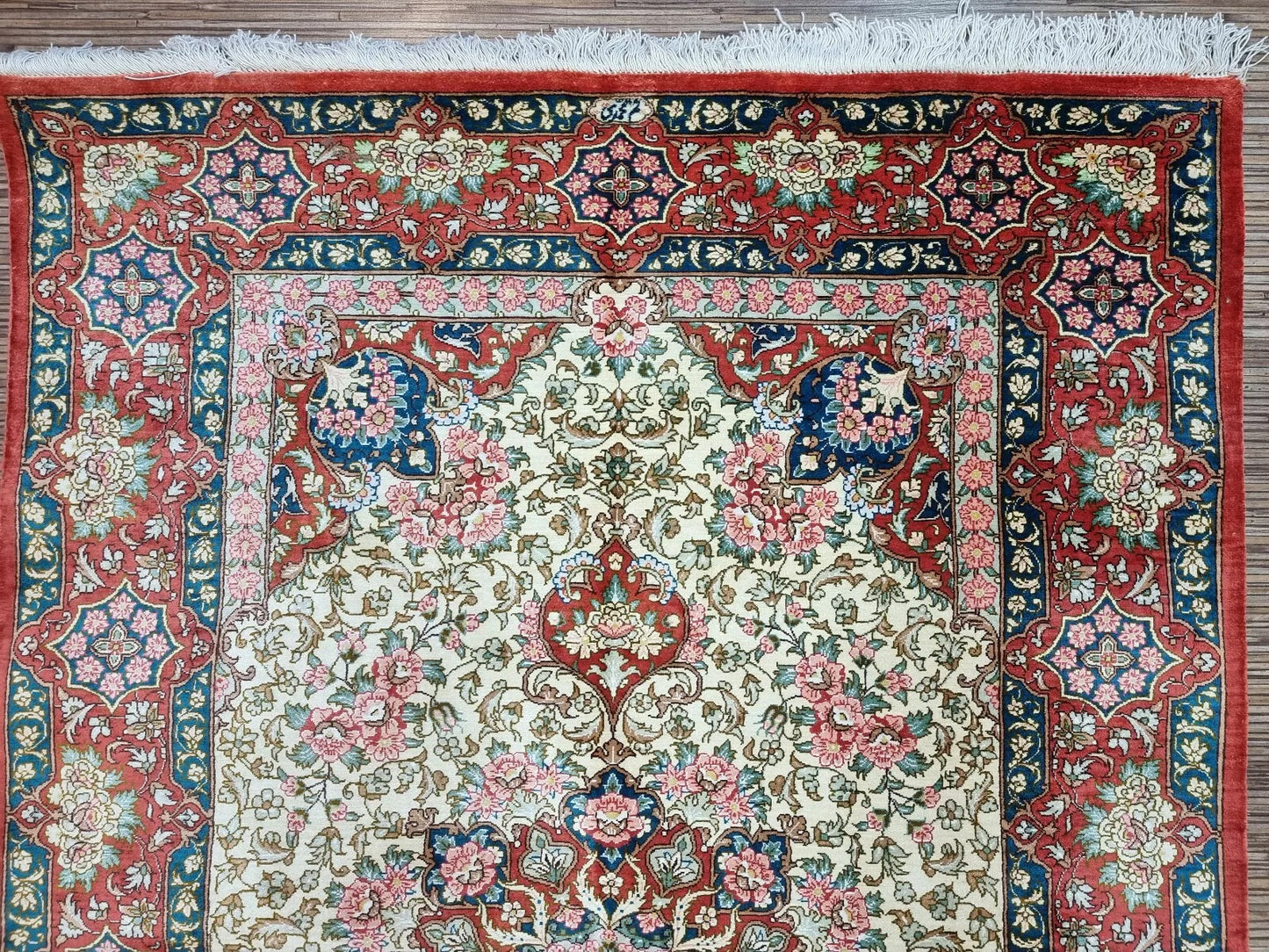 Signed Persian silk rug, adding collector's value and authenticity.
