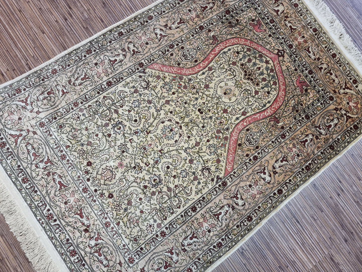 Detailed view of floral motifs on silk rug
