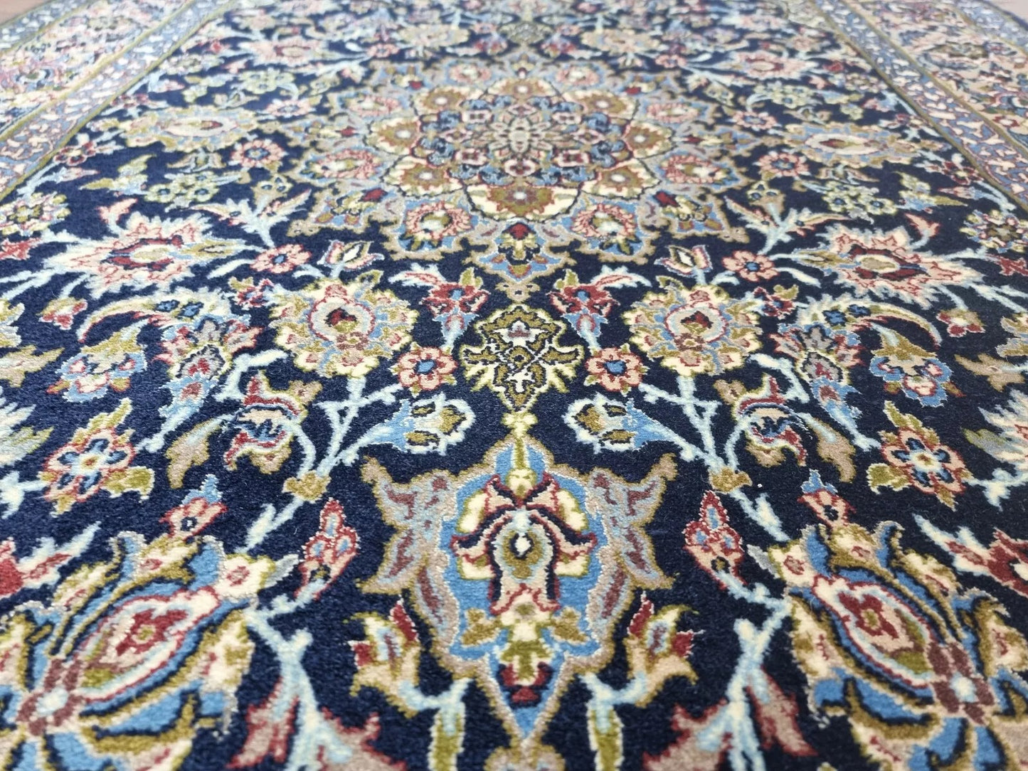 Close-up of hand-knotted kork wool on silk foundation in a 1970s Persian rug
