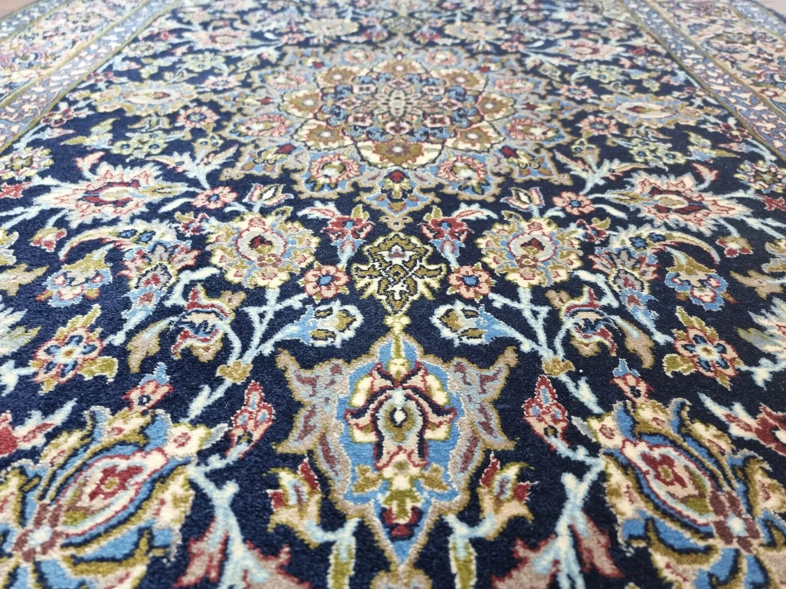 Close-up of hand-knotted kork wool on silk foundation in a 1970s Persian rug
