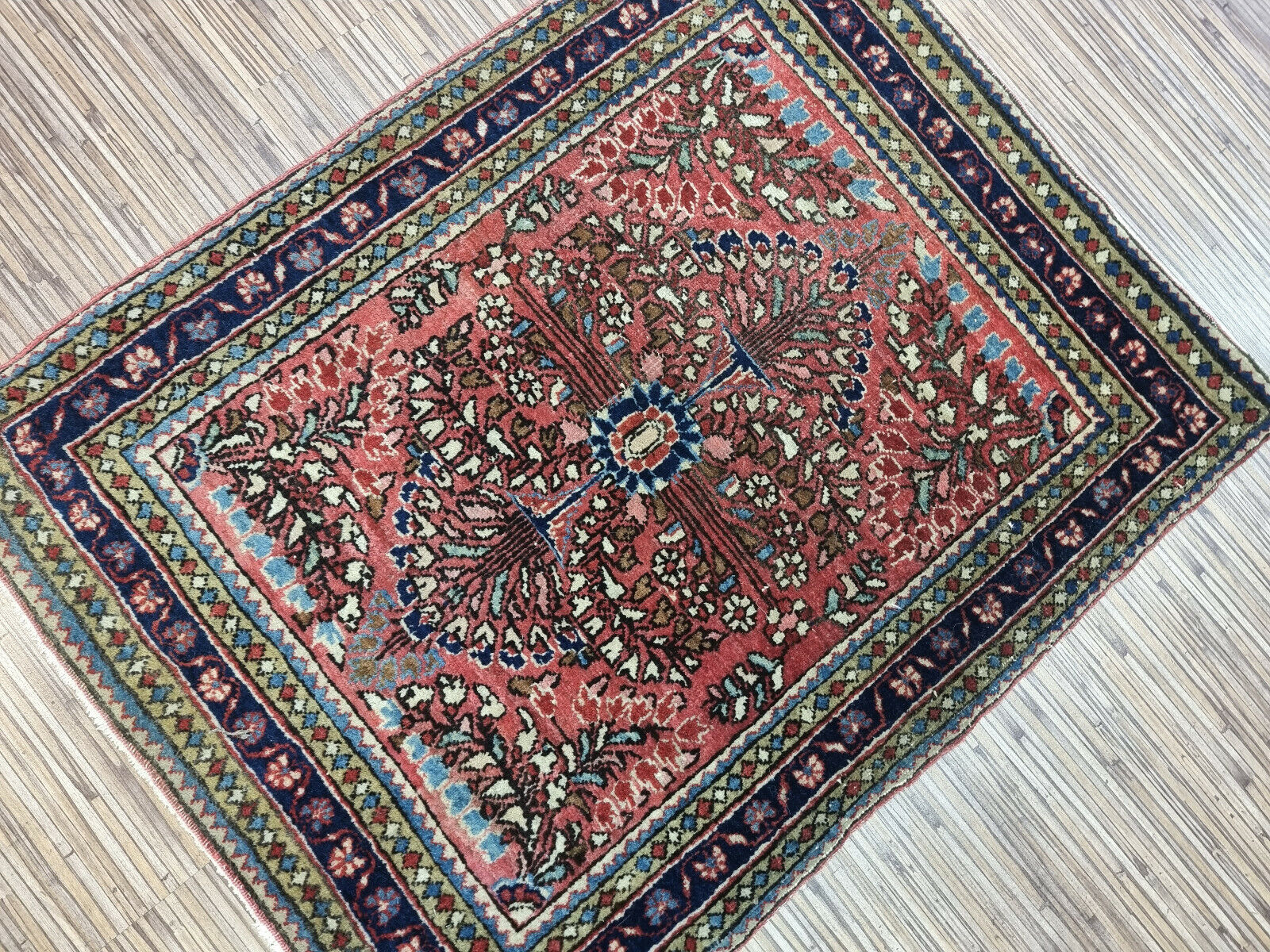 Antique hand-knotted wool rug with a traditional Oriental pattern
