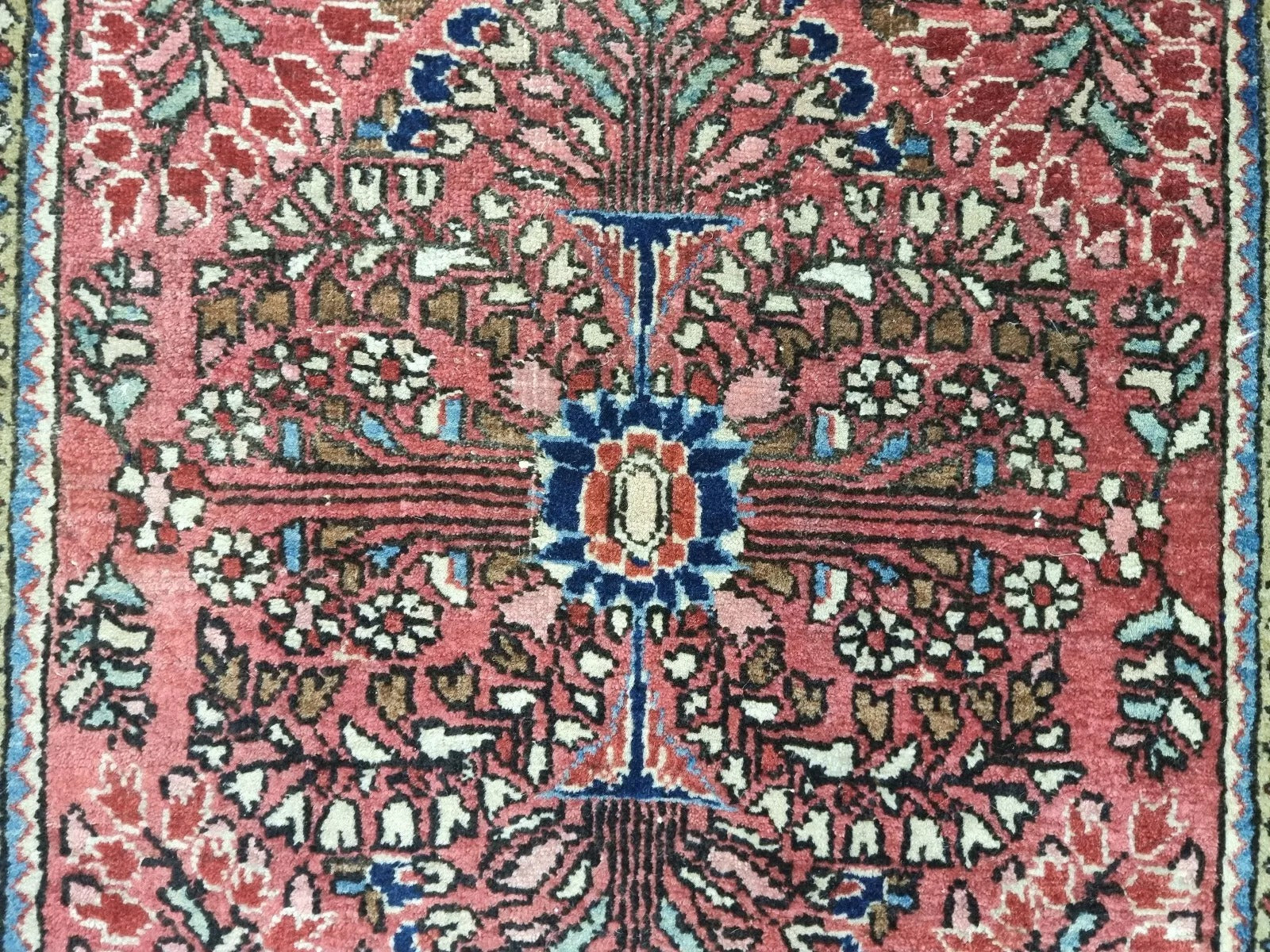 Aged patina and detailed craftsmanship on a Persian-style Sarouk rug
