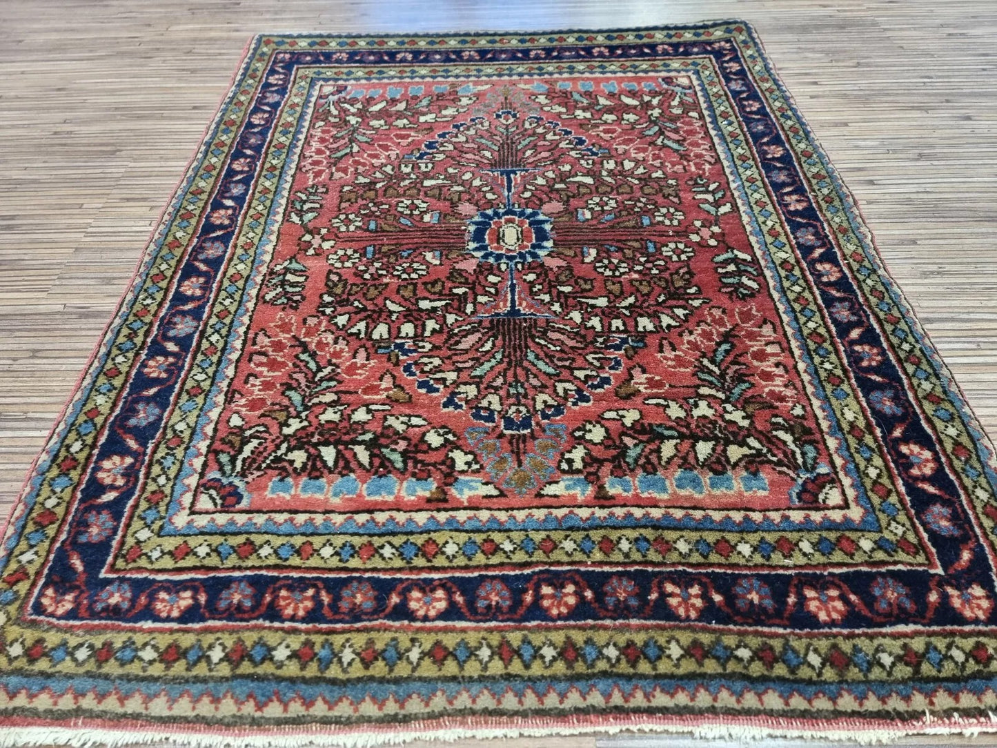 Detailed view of the border design on a century-old Sarouk rug
