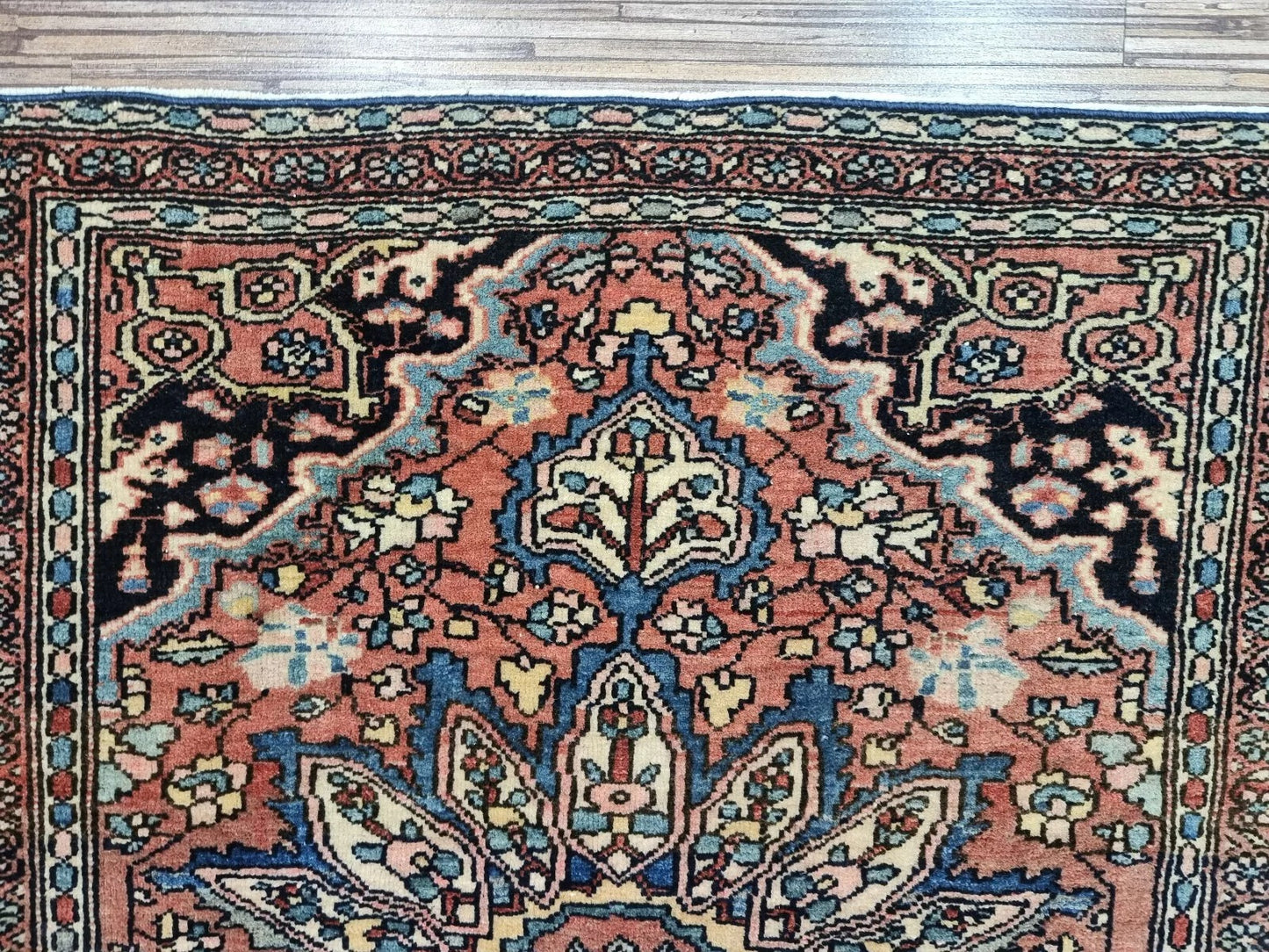 Close-up of fine hand-knotted details on an 1880s Persian Farahan rug
