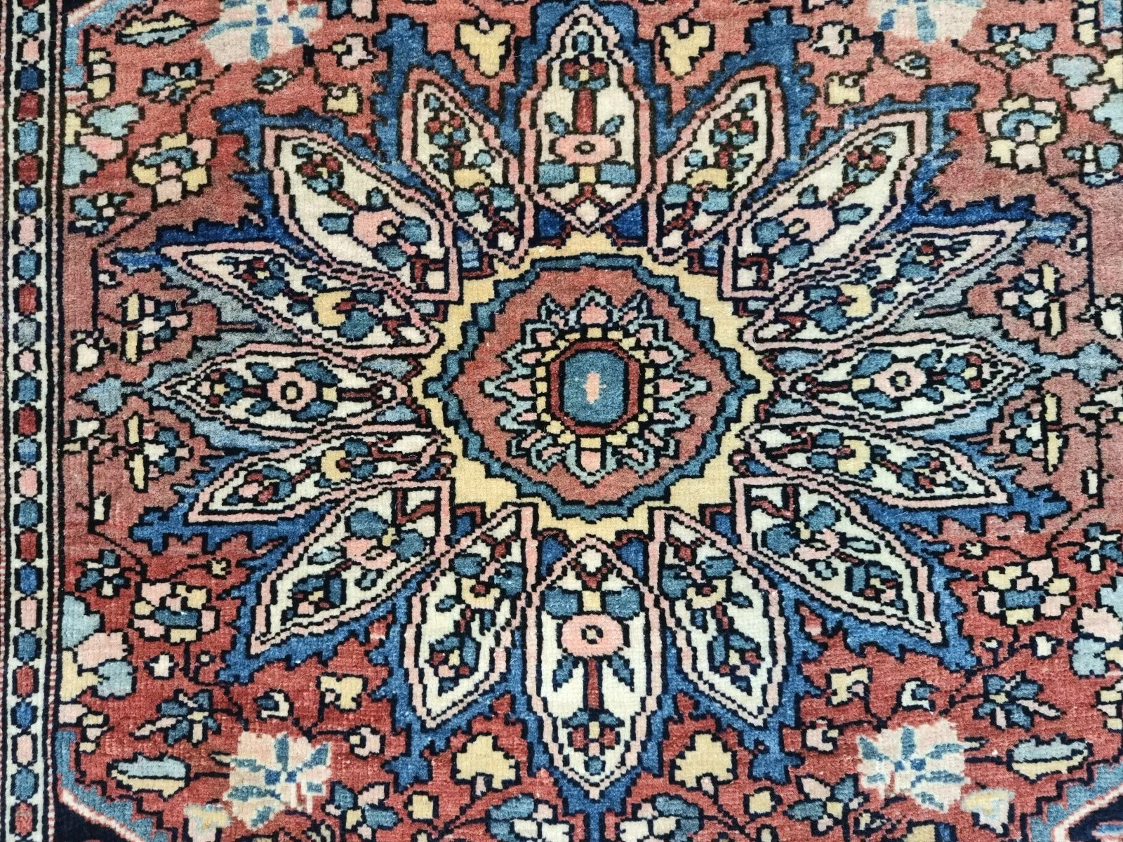 Aged patina and detailed craftsmanship on a Persian-style Farahan rug
