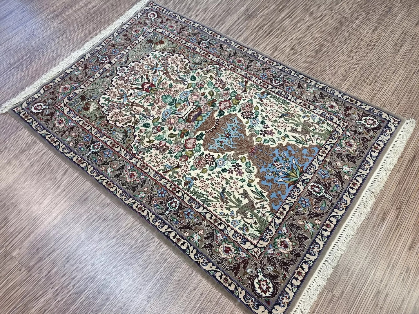 Floral Persian Isfahan rug with elegant wool and silk blend
