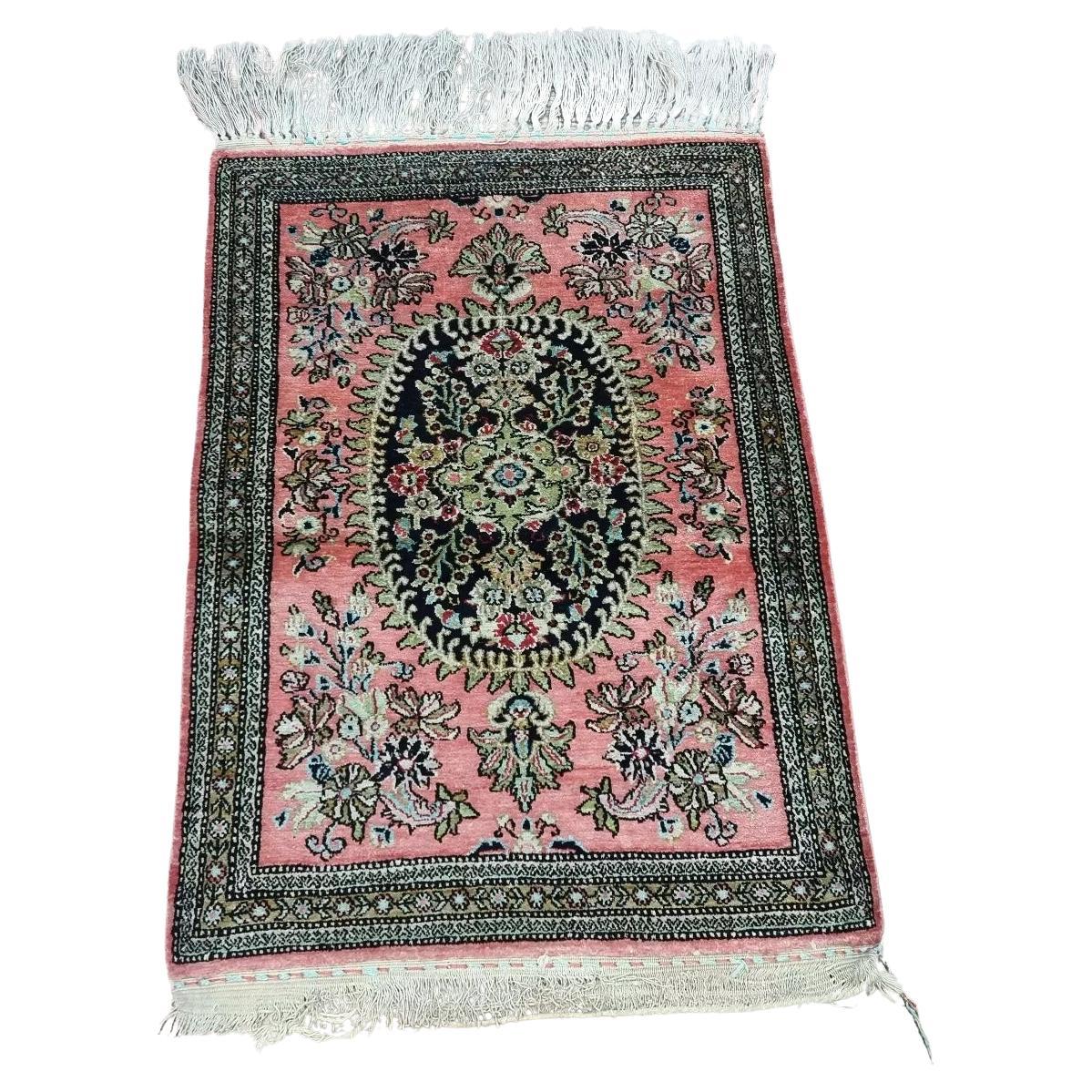 Handmade vintage Persian Qum silk rug with intricate detailing and pink tones
