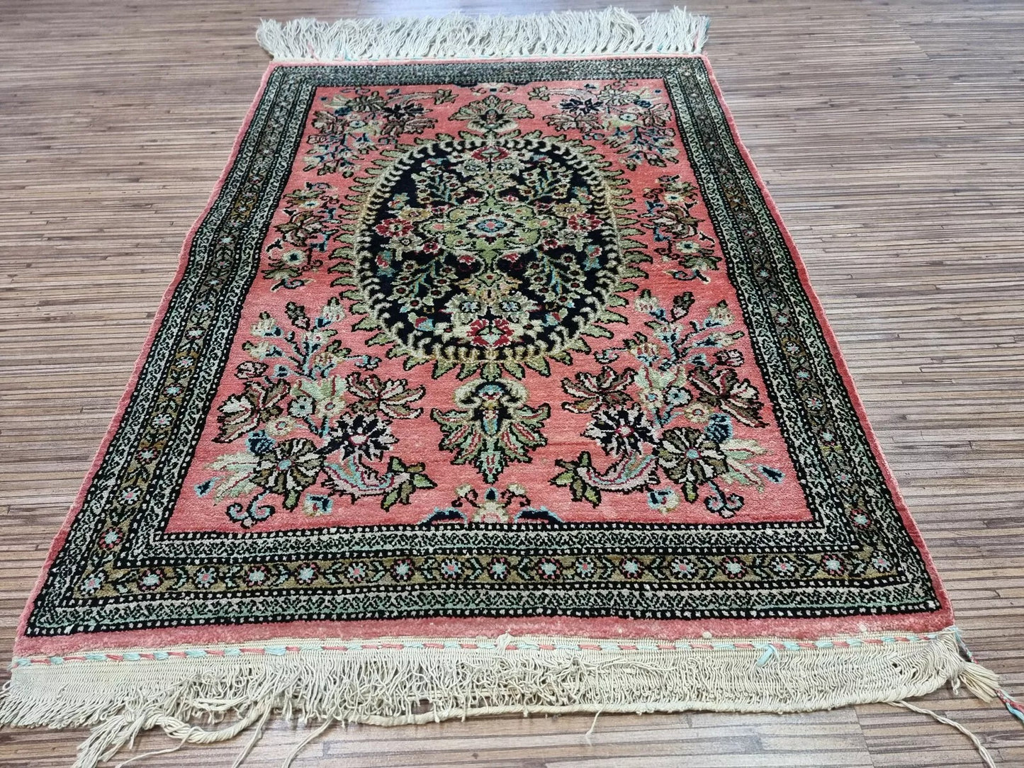 Close-up of a luxurious silk Persian rug, showing fine hand-knotted craftsmanship
