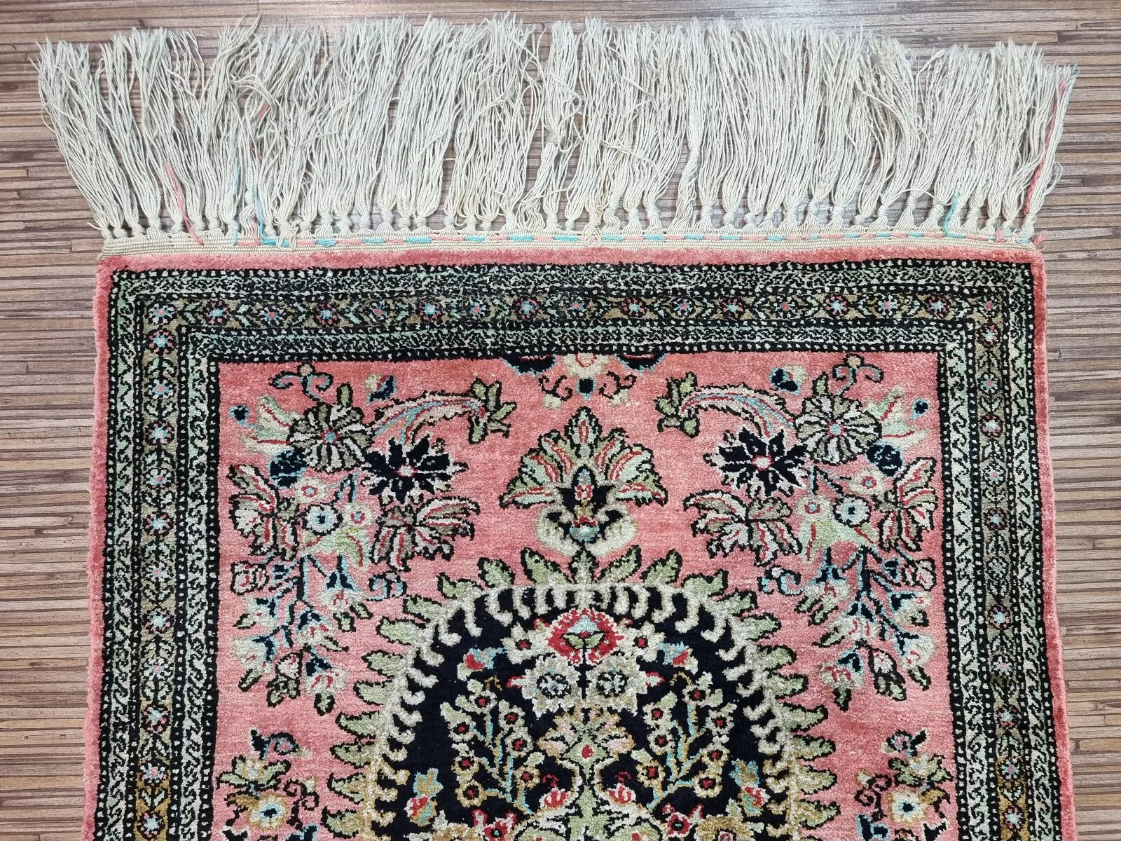 Fine details of a Persian silk rug, featuring classic Persian patterns
