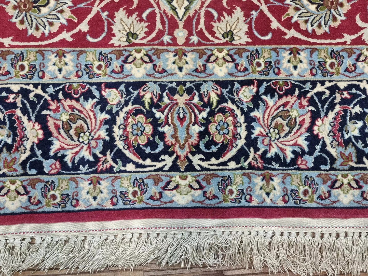 Elegant Persian rug with soft pink hues and luxurious silk texture
