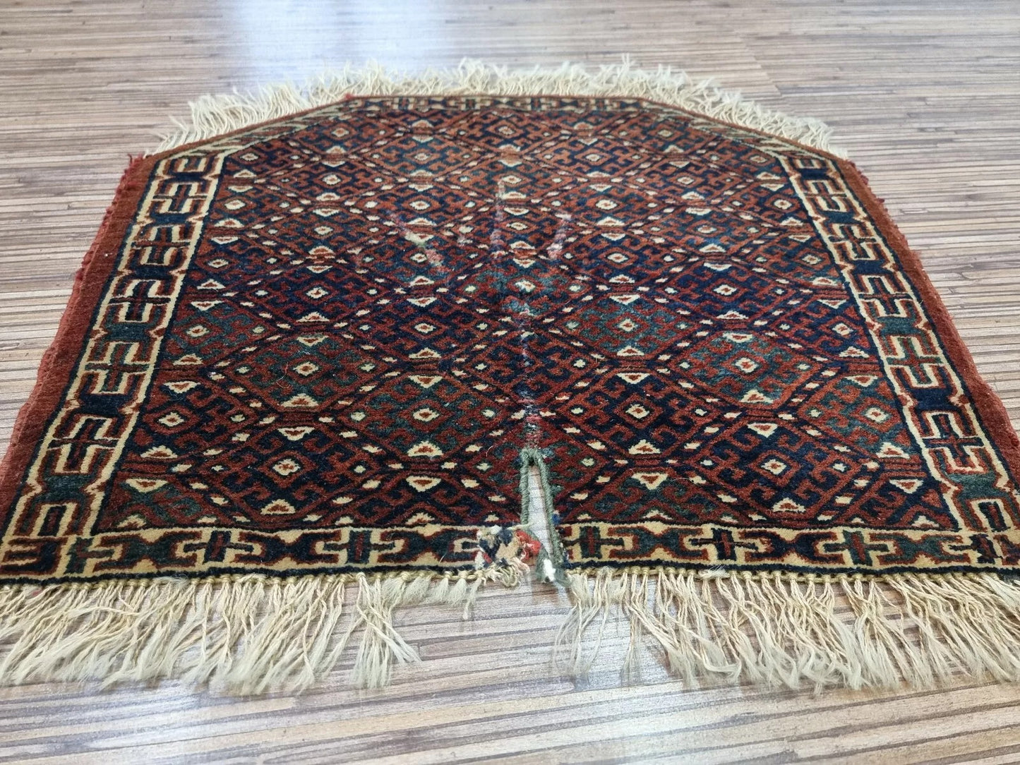 Handwoven Yomud rug with vibrant colors and detailed patterns
