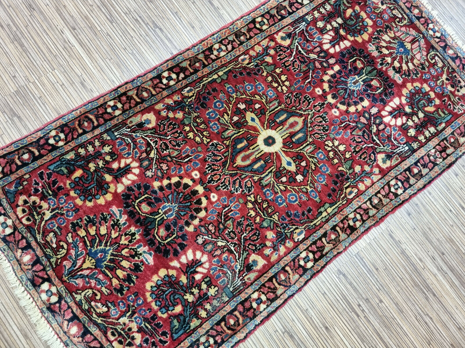 Intricate floral Sarouk rug design
