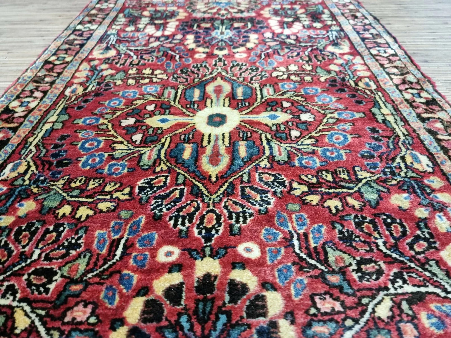 Vintage Sarouk rug vibrant red hues
