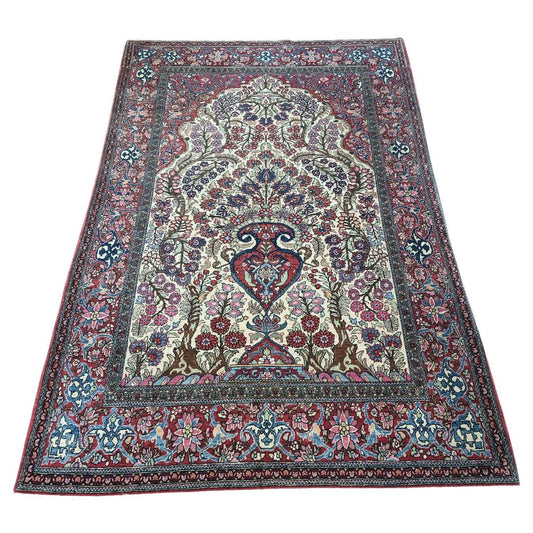 Vintage Wool Isfahan Prayer Rug (1900s): A captivating Isfahan prayer rug featuring a central medallion with floral and geometric motifs in rich reds, blues, and creams. (4.6' x 6.8')