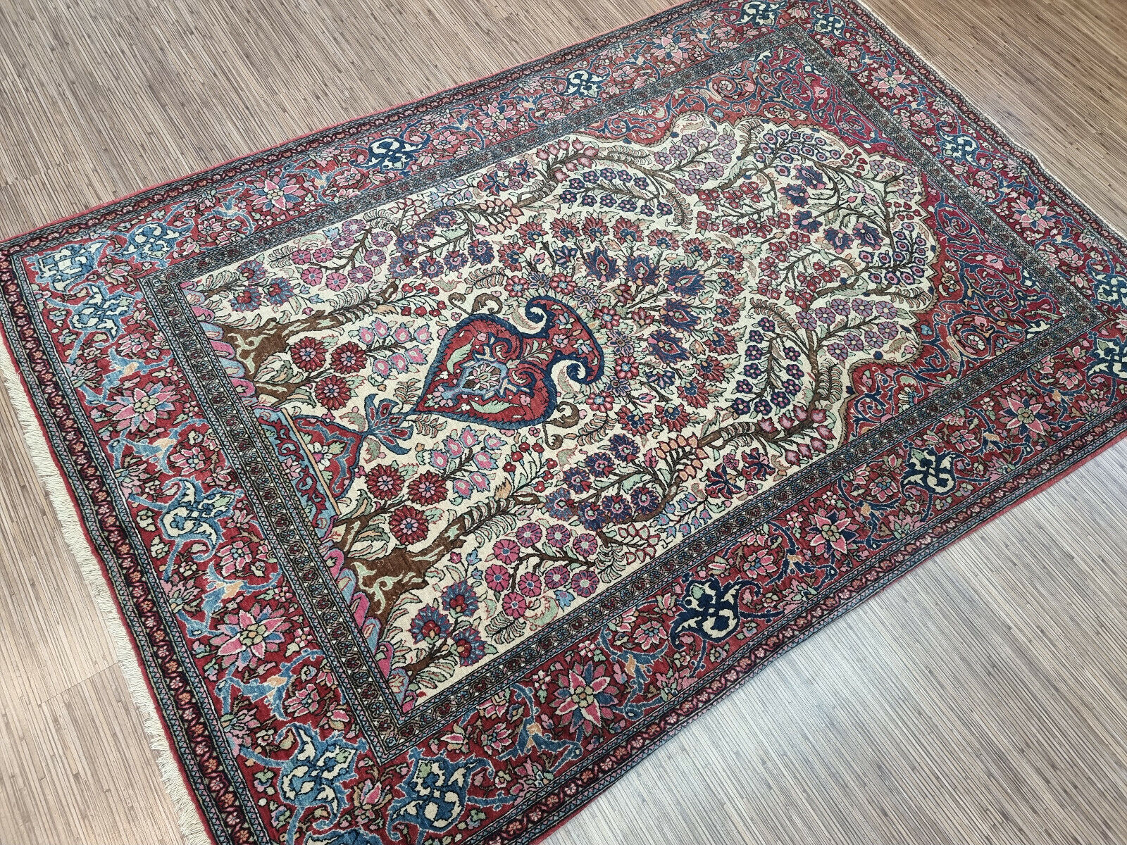 Vintage Wool Isfahan Prayer Rug (1900s): The intricate floral motifs within the central medallion are a testament to the weaver's skill. (Close-up)