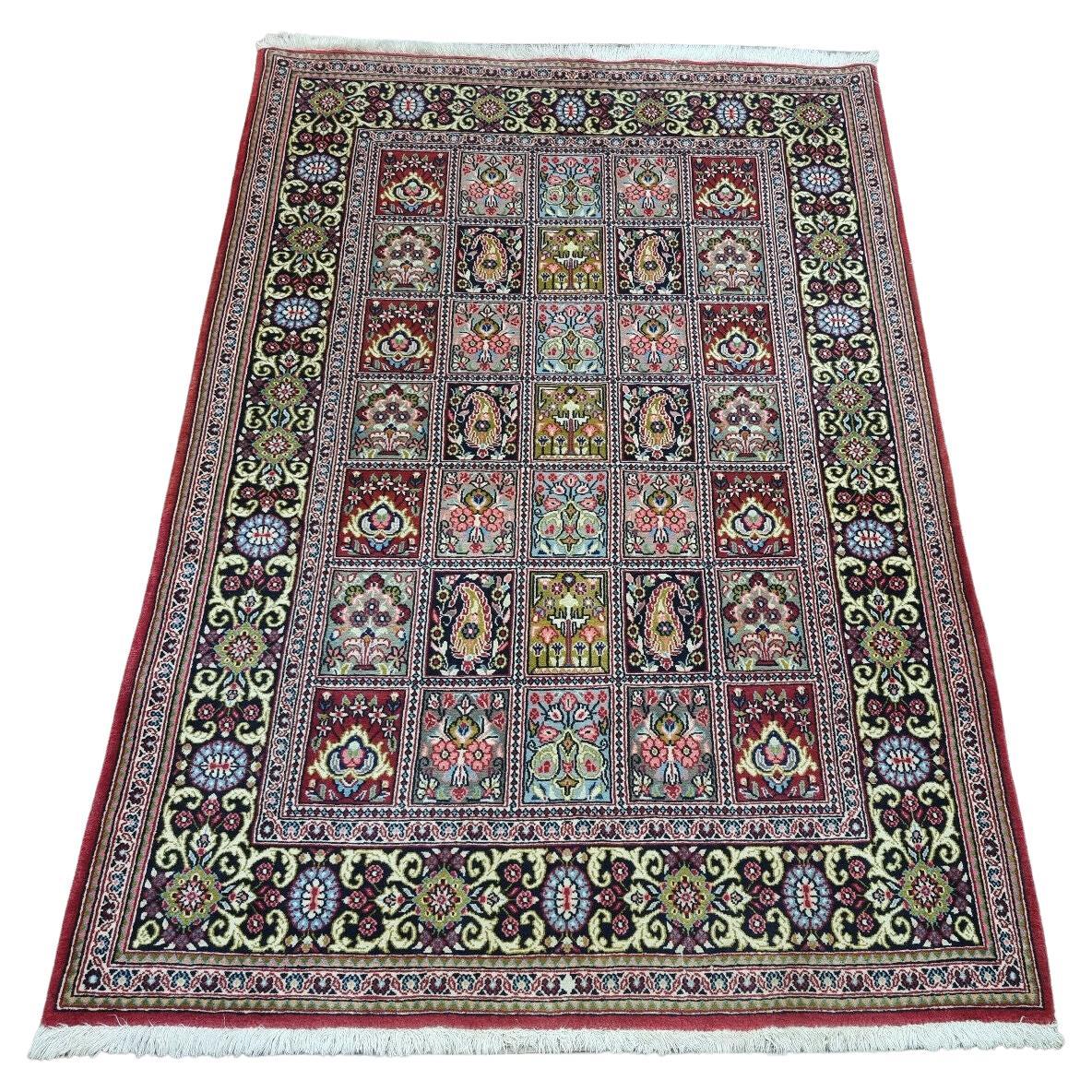 Vintage Persian Elegance: Captivating 1970s Qum-style rug with geometric & floral patterns in red, blue, green & cream (3.6' x 5.1').