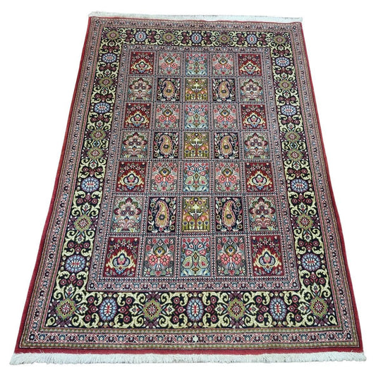 Vintage Persian Elegance: Captivating 1970s Qum-style rug with geometric & floral patterns in red, blue, green & cream (3.6' x 5.1').