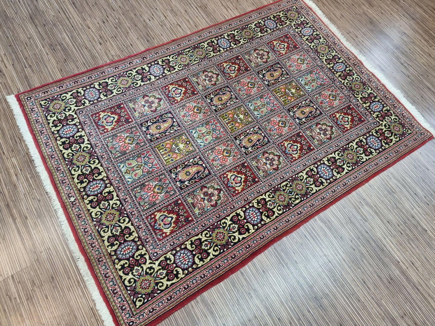 Boho Beauty: Handwoven Wool Rug (3.6' x 5.1') in Persian style with geometric & floral patterns (reds, blues, greens).