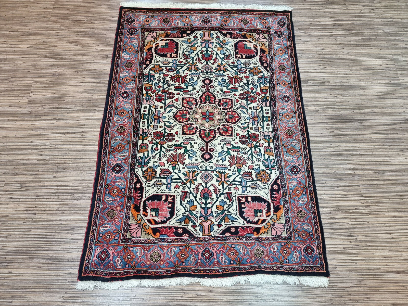 Blue Hues and Beyond: Vintage Bidjar Rug (3.4' x 5') features a symmetrical design with pops of color (reds, whites, green, yellow).