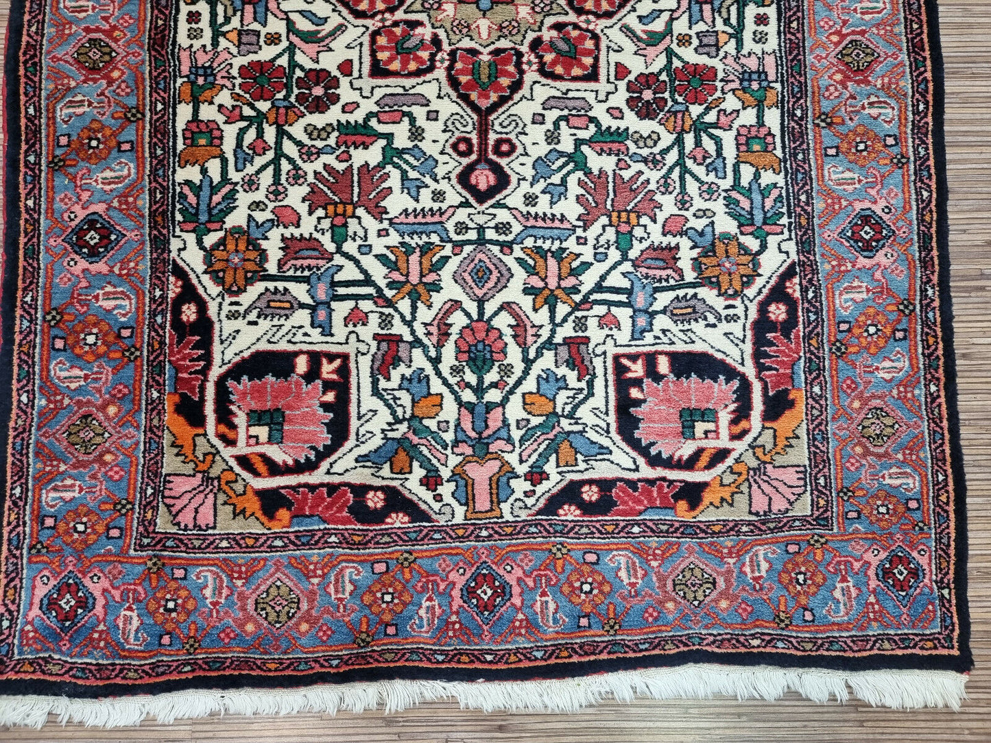 Vintage Charm for Modern Living: Handwoven Bidjar Rug (3.4' x 5') in a captivating symmetrical design (blues, reds, whites).