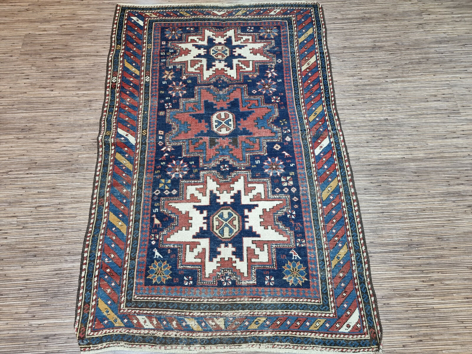 Ancient Tales Unraveled: Explore the intricate patterns and motifs that whisper stories of distant lands and cultures in this Antique Shirvan Rug.