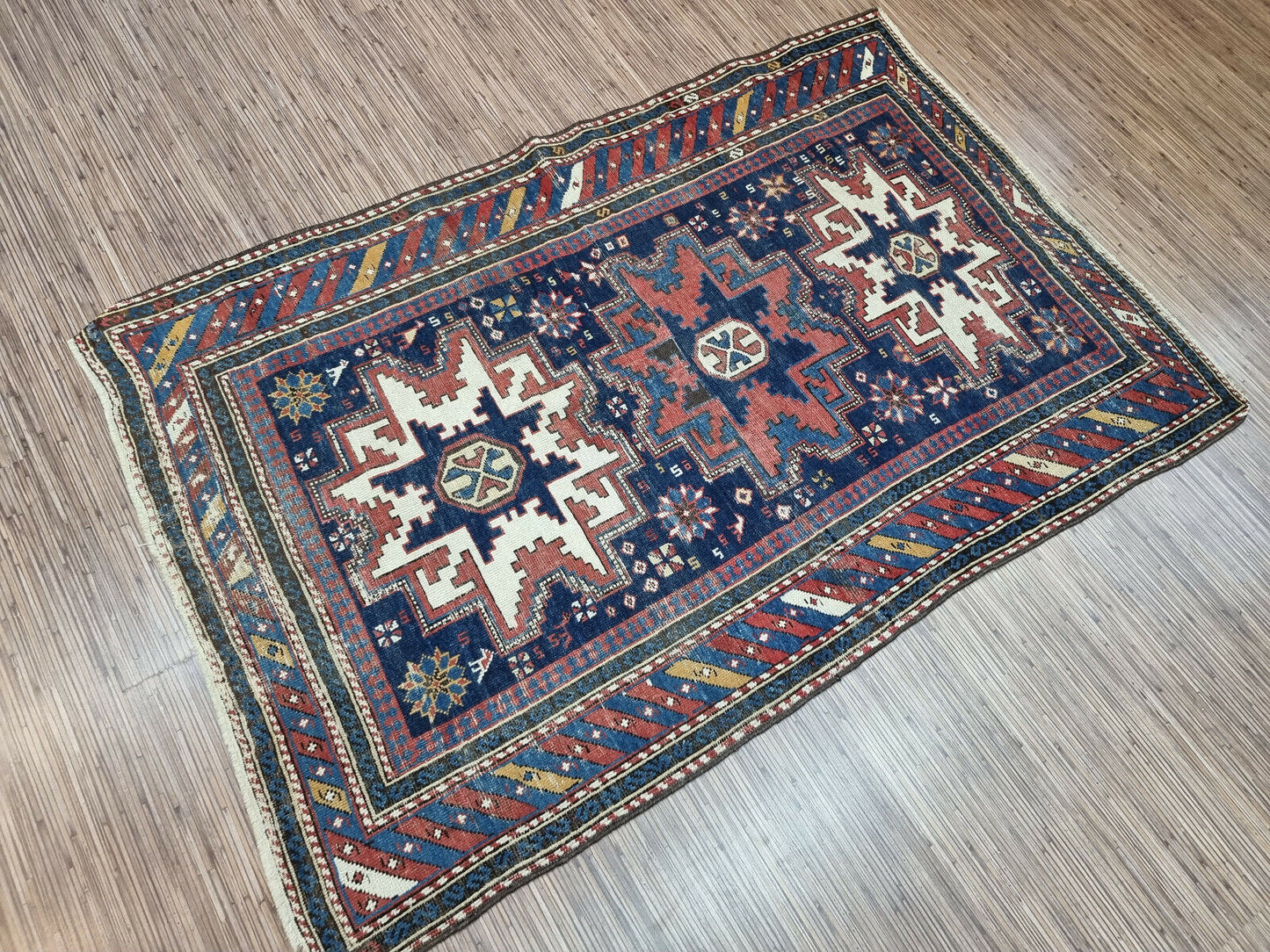 A Piece of History: Own a piece of history with this Antique Shirvan Rug, a captivating blend of artistry and cultural heritage.