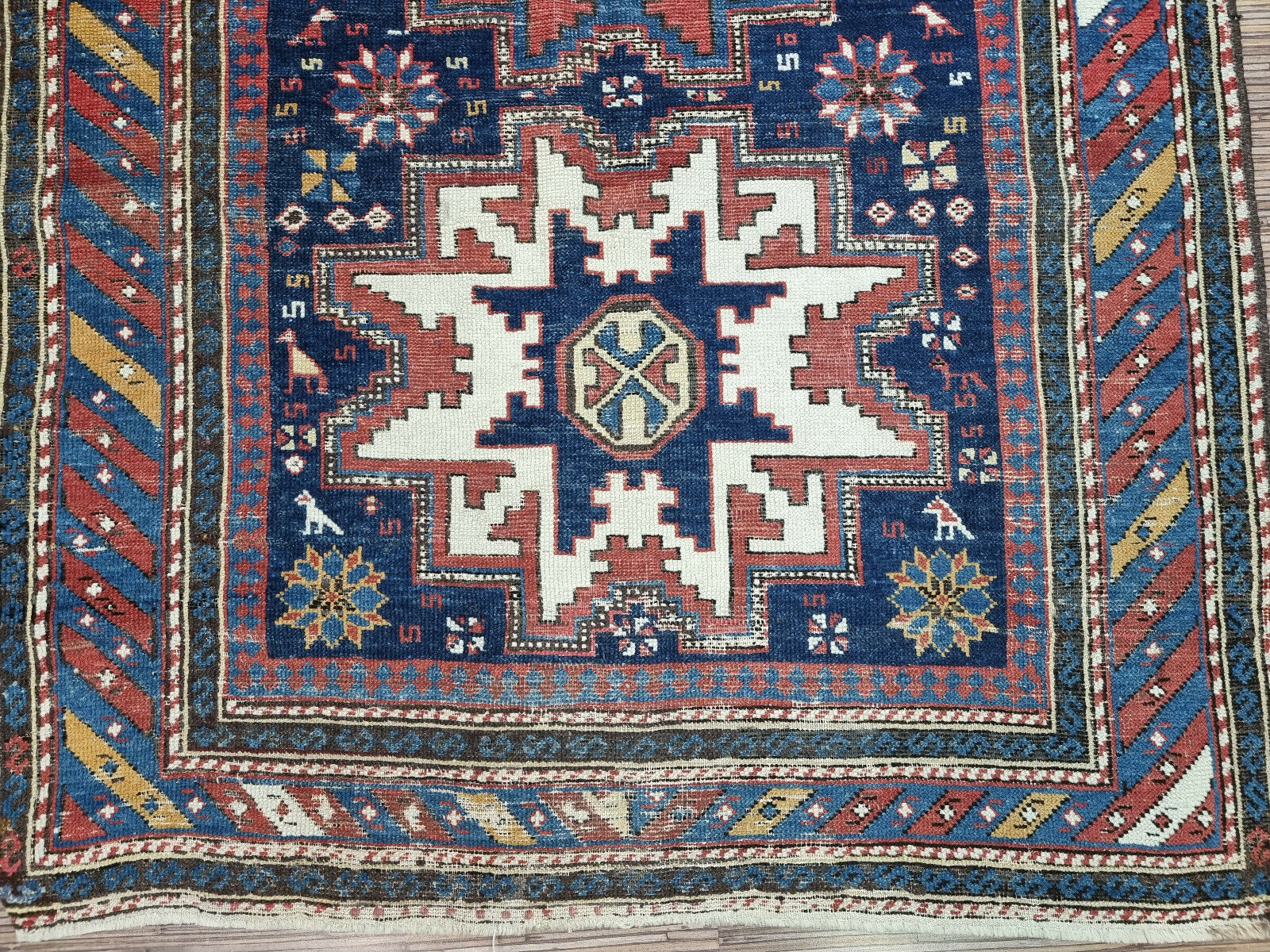 Medallion Rug with Intricate Motifs: Discover the symbolism and storytelling traditions embodied in the medallions and motifs of this Antique Shirvan Rug.