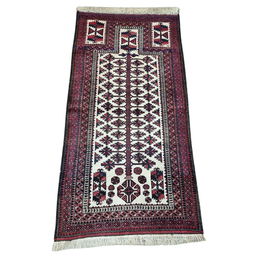 Handmade Afghan Beauty: Vintage Baluch Prayer Rug (1950s) with intricate geometric design (cream, red, blue).