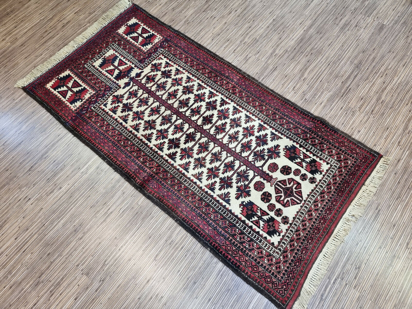 Vintage Prayer Rug: 1950s Afghan Baluch Rug features a captivating geometric design and symbolic motifs.