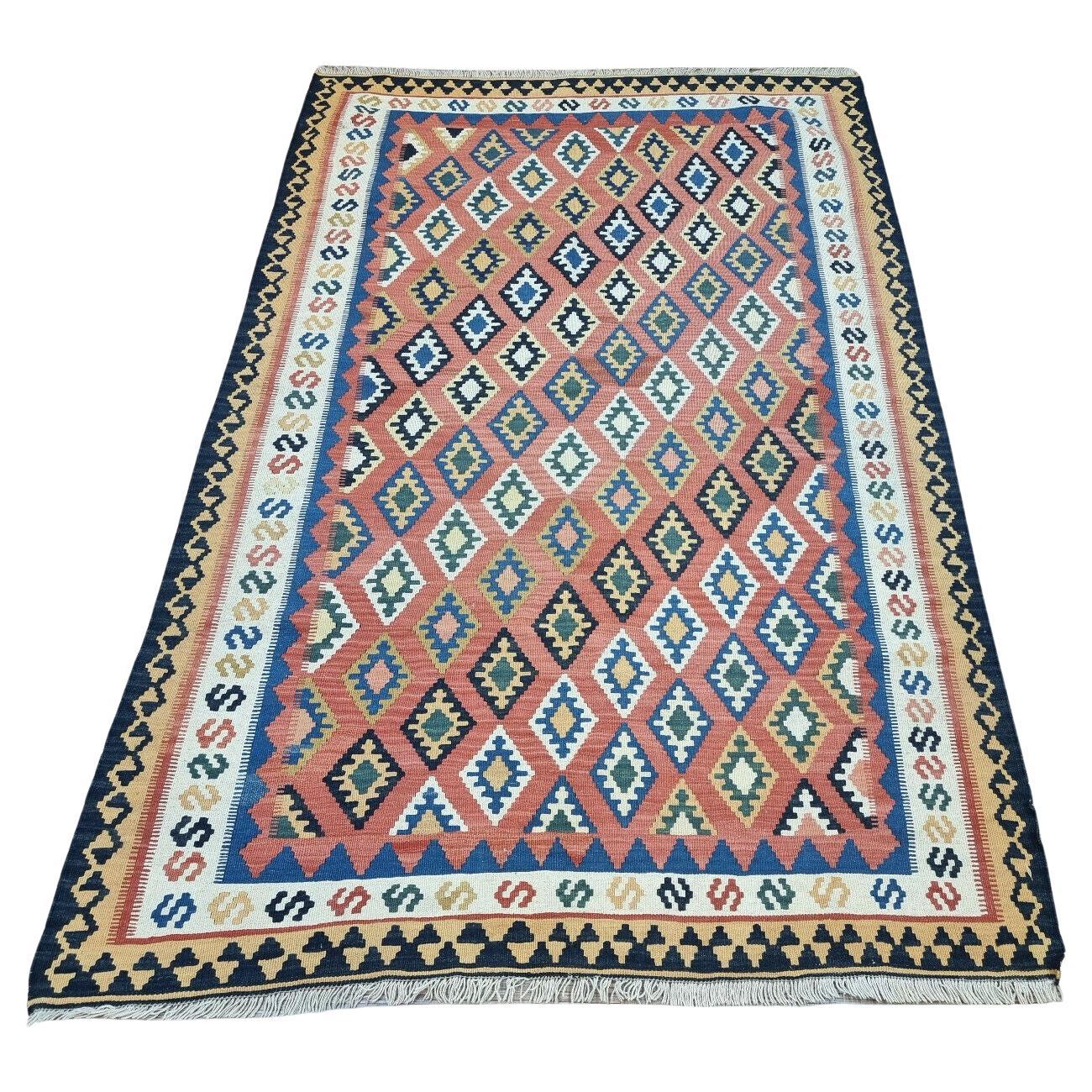 Vintage Persian Magic: Handwoven Ardabil Kilim Rug (1970s) with vibrant diamond shapes (red, blue, green, beige).