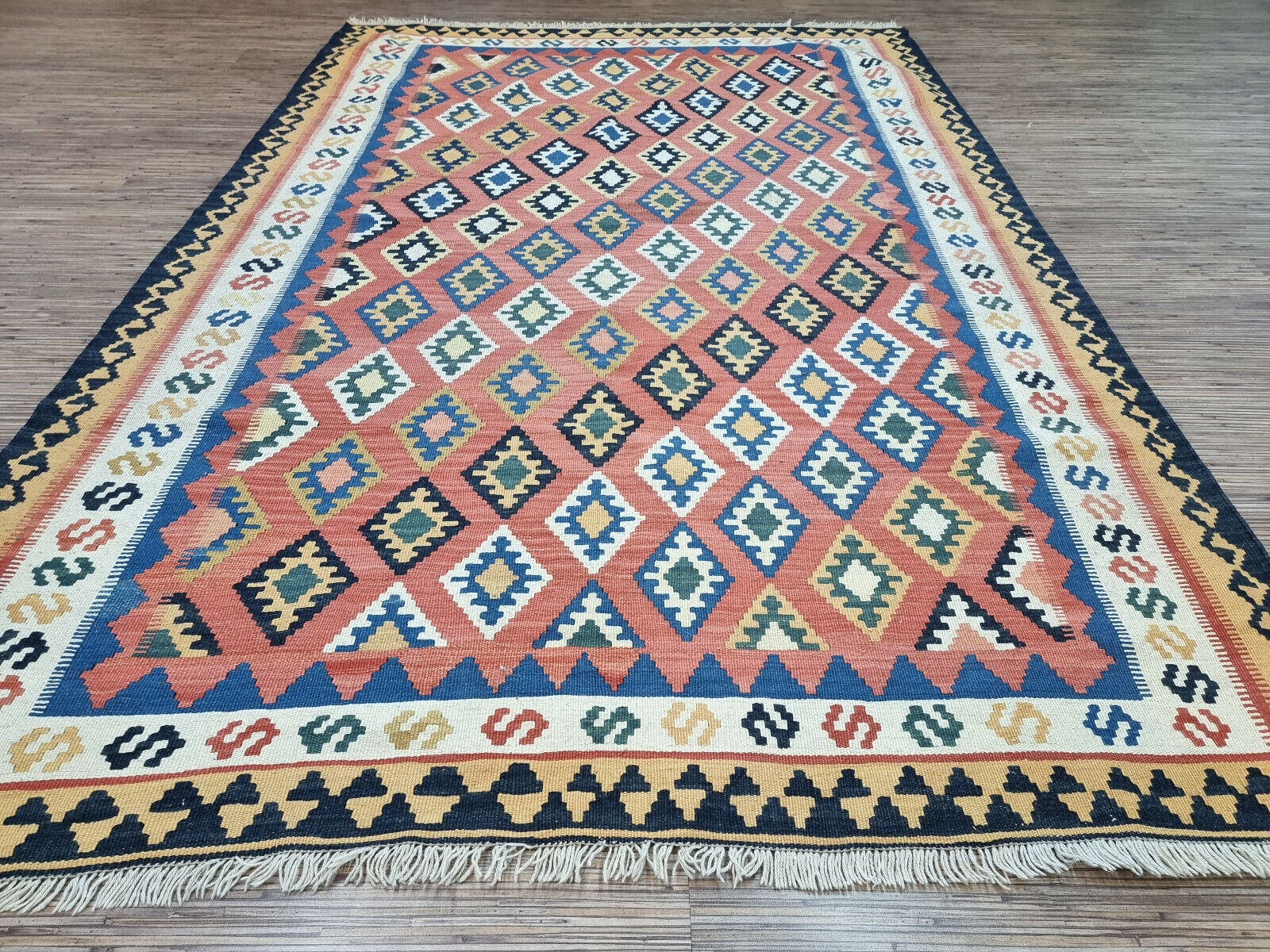 Diamond Delight: Vintage Persian Ardabil Kilim Rug (4.9' x 7.2') features a captivating diamond-shaped pattern in red, blue, green, and beige.