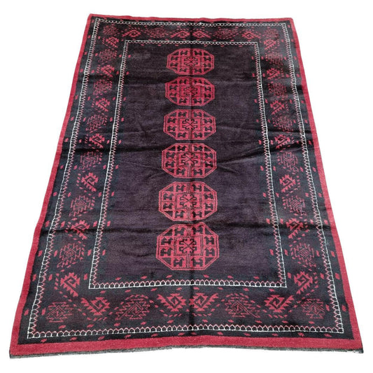 Handwoven Afghan Baluch rug in rich reds and indigo, infusing your space with mid-century charm.