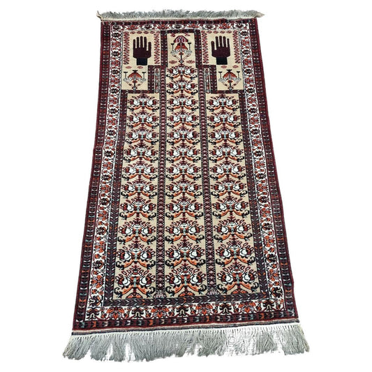 Vintage Afghan Baluch prayer rug (1960s) adds tradition and elegance with its geometric patterns and symbolic motifs.