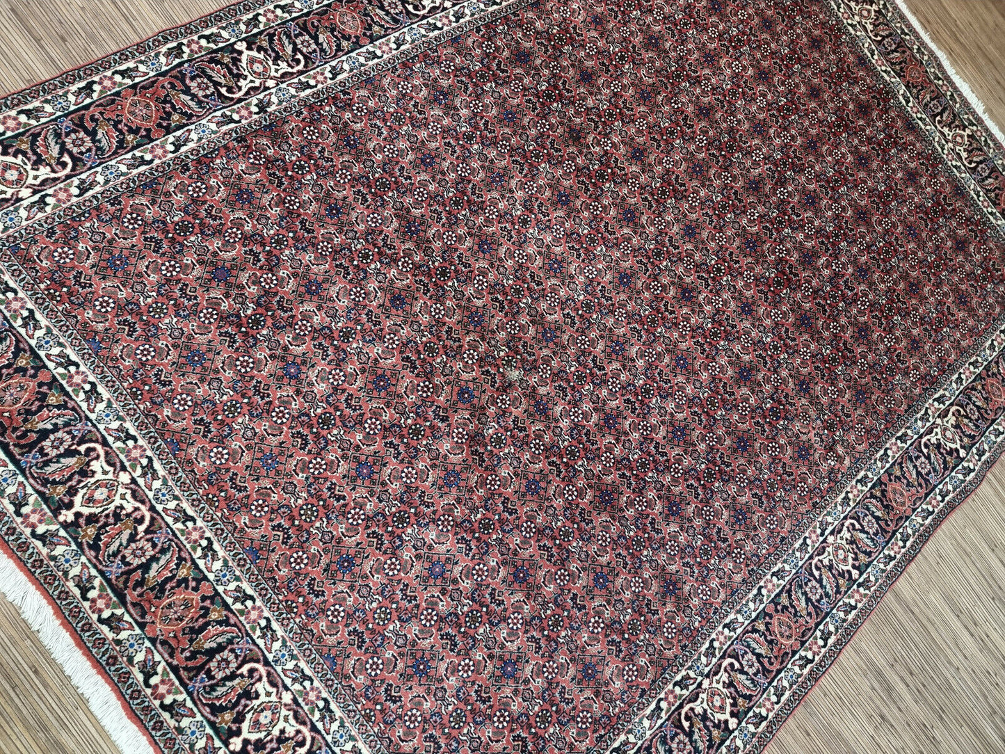 Vintage Persian Rug: A Masterpiece of Design: Experience the captivating beauty of this handwoven Persian Bidjar rug (1970s), featuring intricate details and a warm color palette.