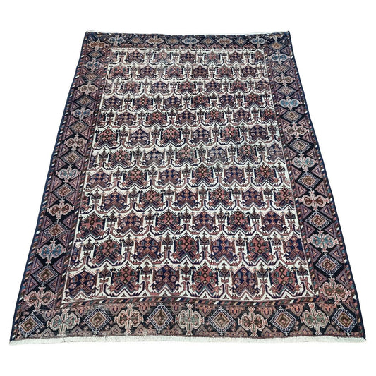 Handwoven Afshar rug in deep blue, red, cream, and beige adds timeless elegance (1920s).