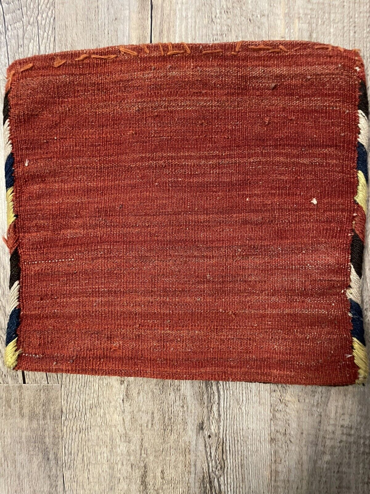 Backside of a handmade antique Persian Gashkai small bag (1900s) crafted from high-quality natural wool in good condition, showcasing its simple design and durability.