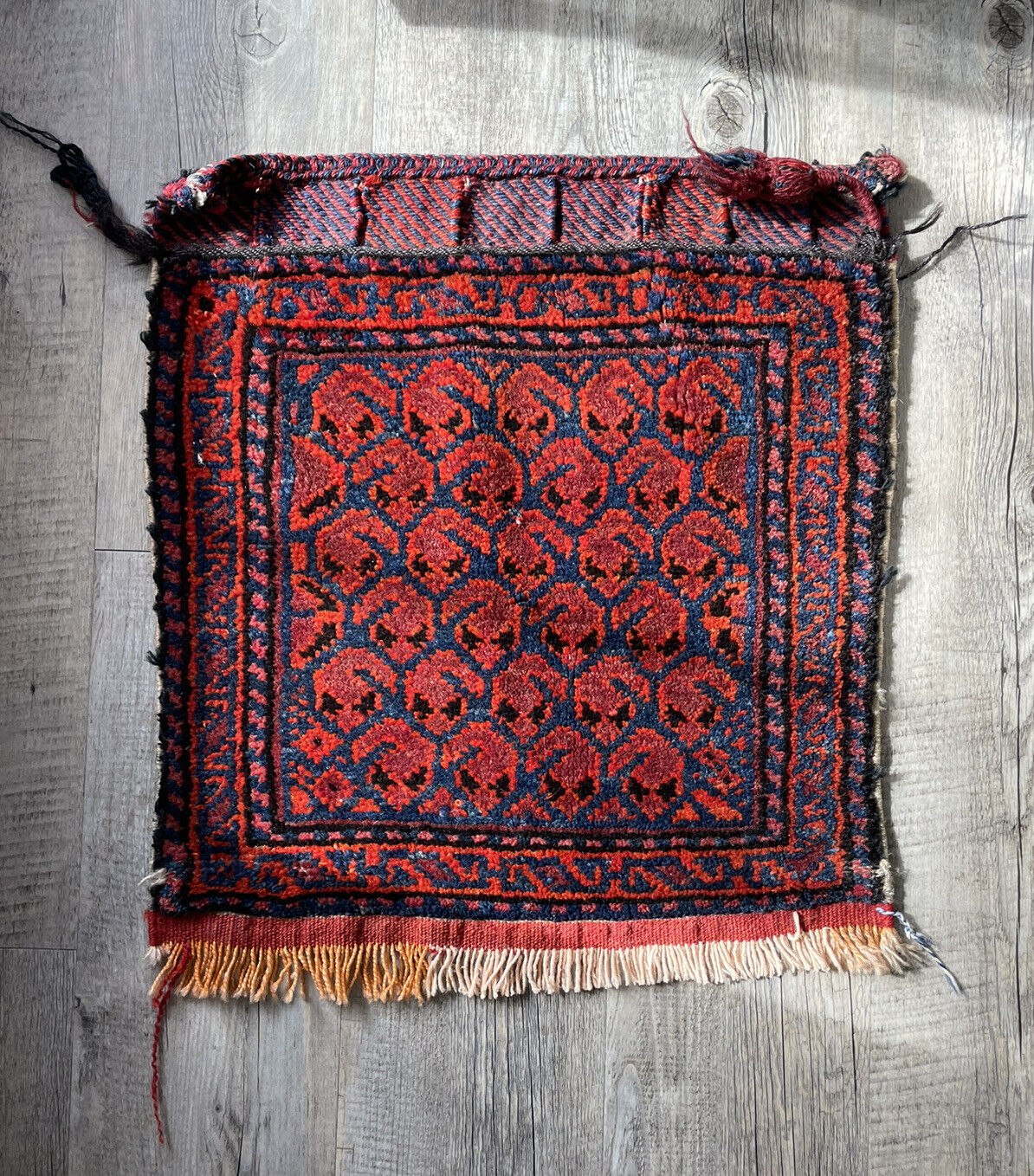 Full Bagface: A handwoven antique Persian Shiraz bagface (1.3' x 1.5') in its entirety, displaying a traditional design with a central medallion and intricate geometric borders.