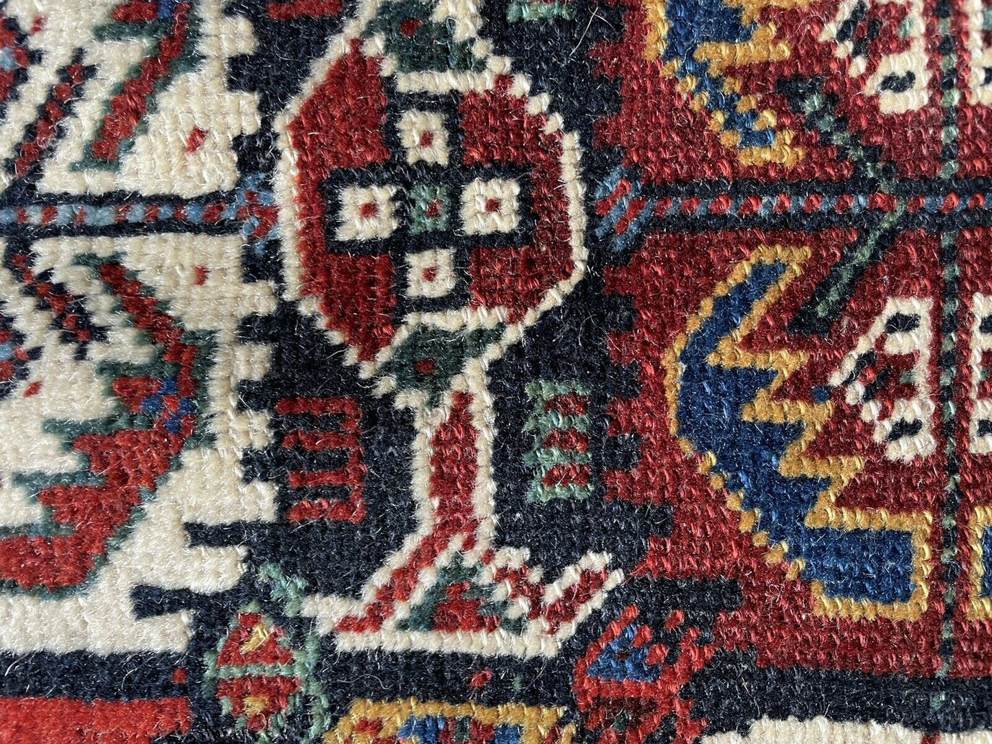 Versatility as a Rug: The Gashgai bagface (1880s) laid flat on a surface, showcasing its versatility as a decorative rug or wall hanging.