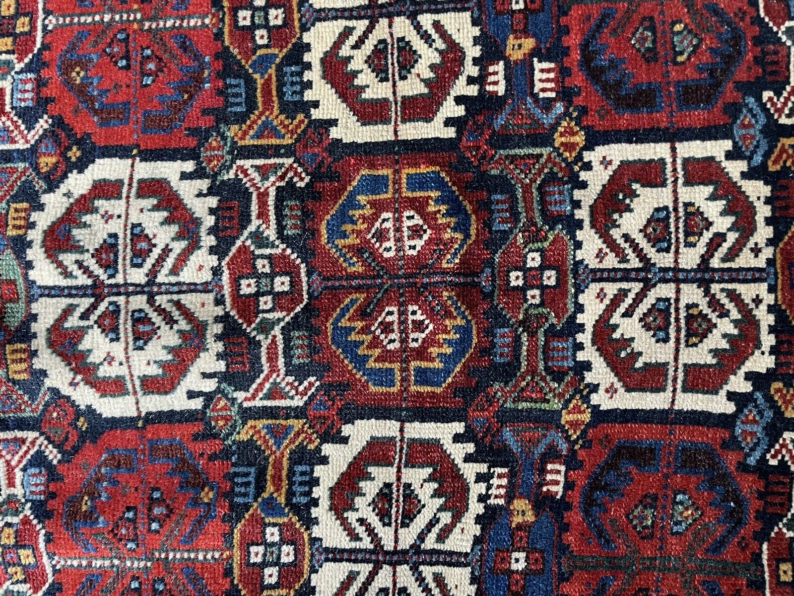 Full Bagface: A handwoven antique Persian Gashgai bagface (2.2' x 2.7') in its entirety, displaying a traditional design with a central medallion, geometric borders, and symbolic tribal elements.