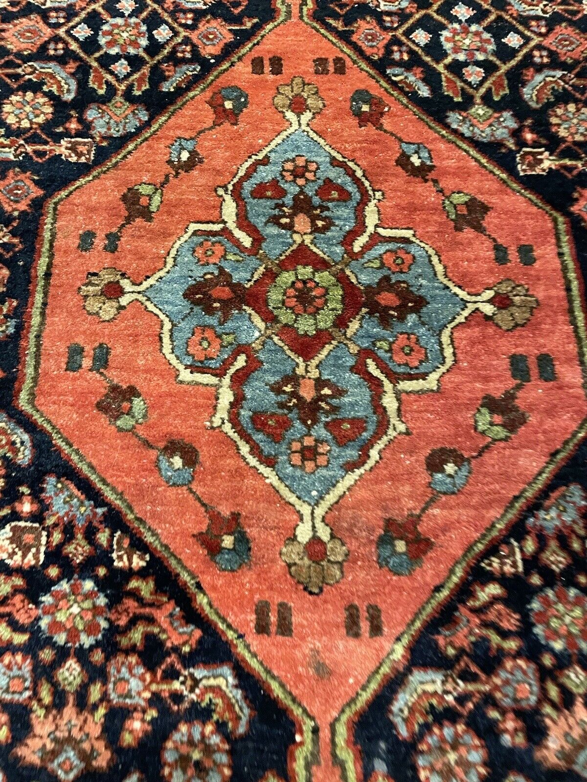 Aged wool Bidjar rug with a central medallion and rich borders
