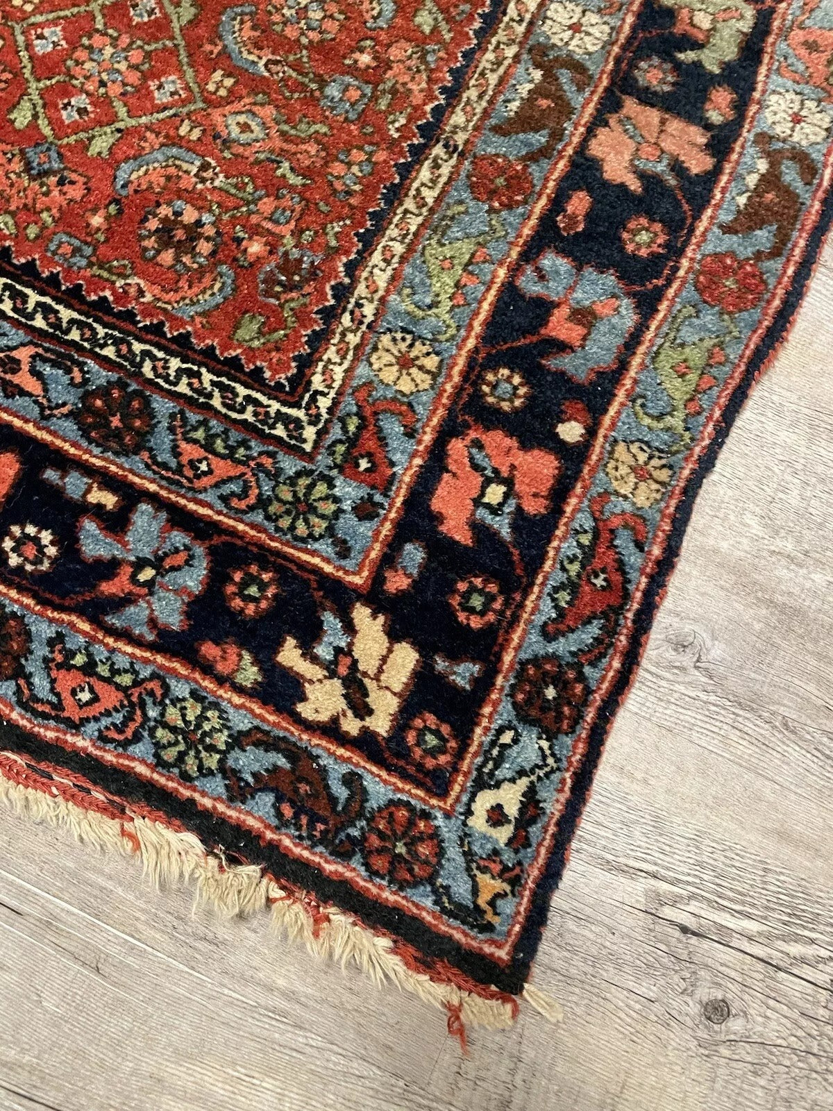 Intricate handwoven patterns on a vintage Bidjar wool rug
