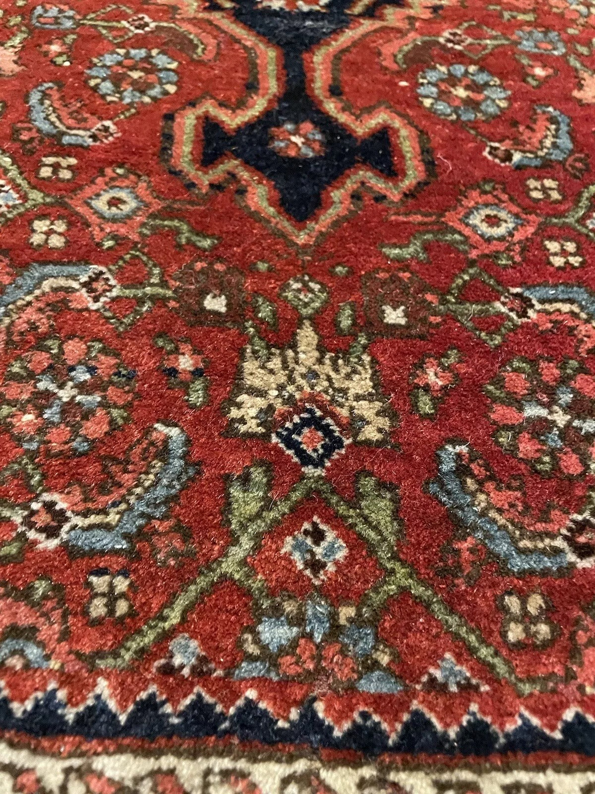 Detailed corner view of an antique Bidjar wool rug
