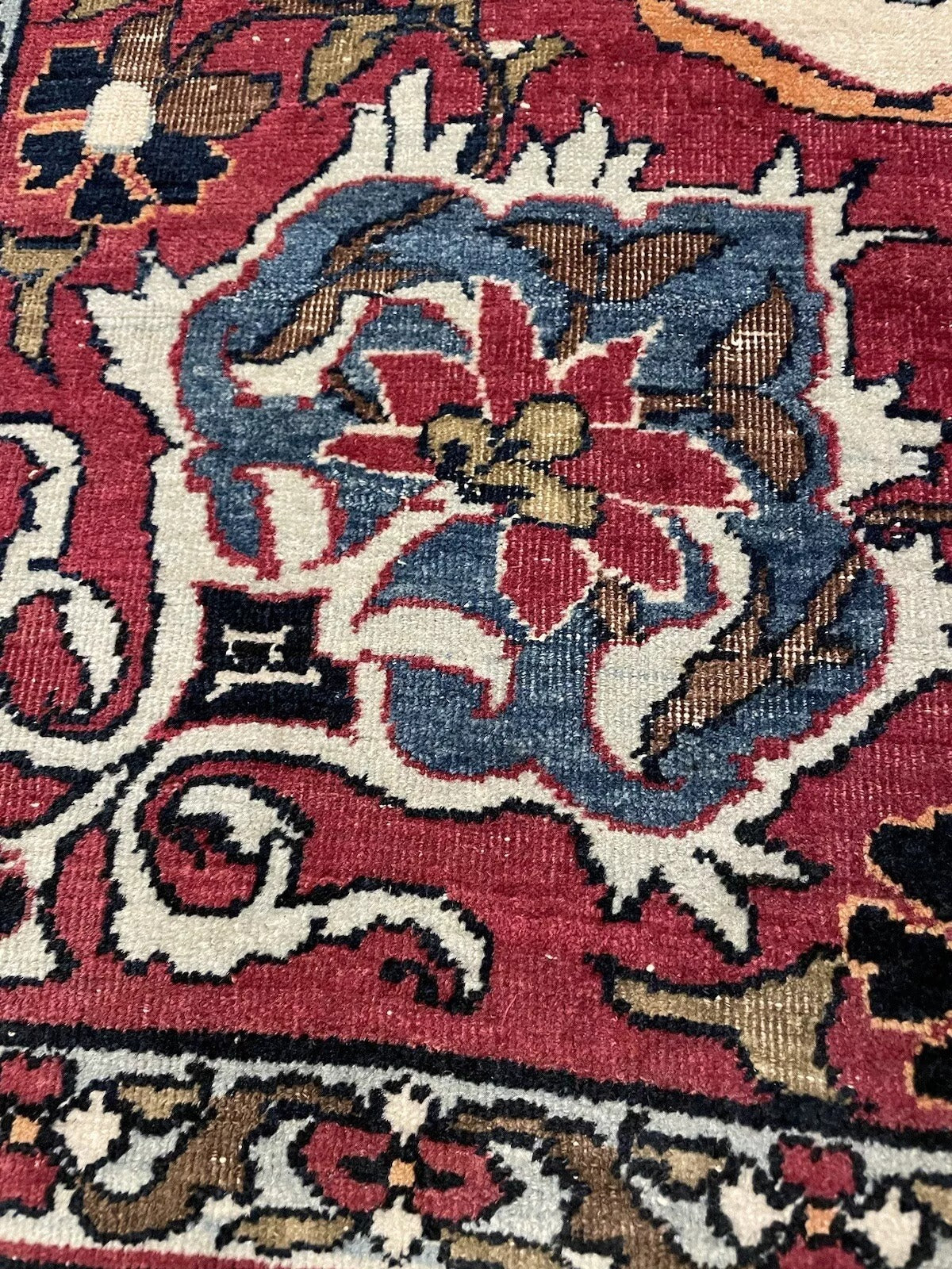 Traditional handmade Kerman Lavar rug in deep red, blue, and cream hues
