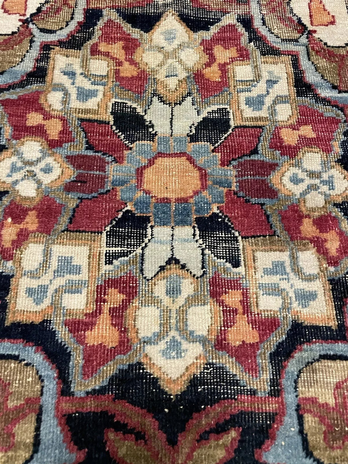 Intricate handwoven patterns on a vintage Kerman Lavar wool rug
