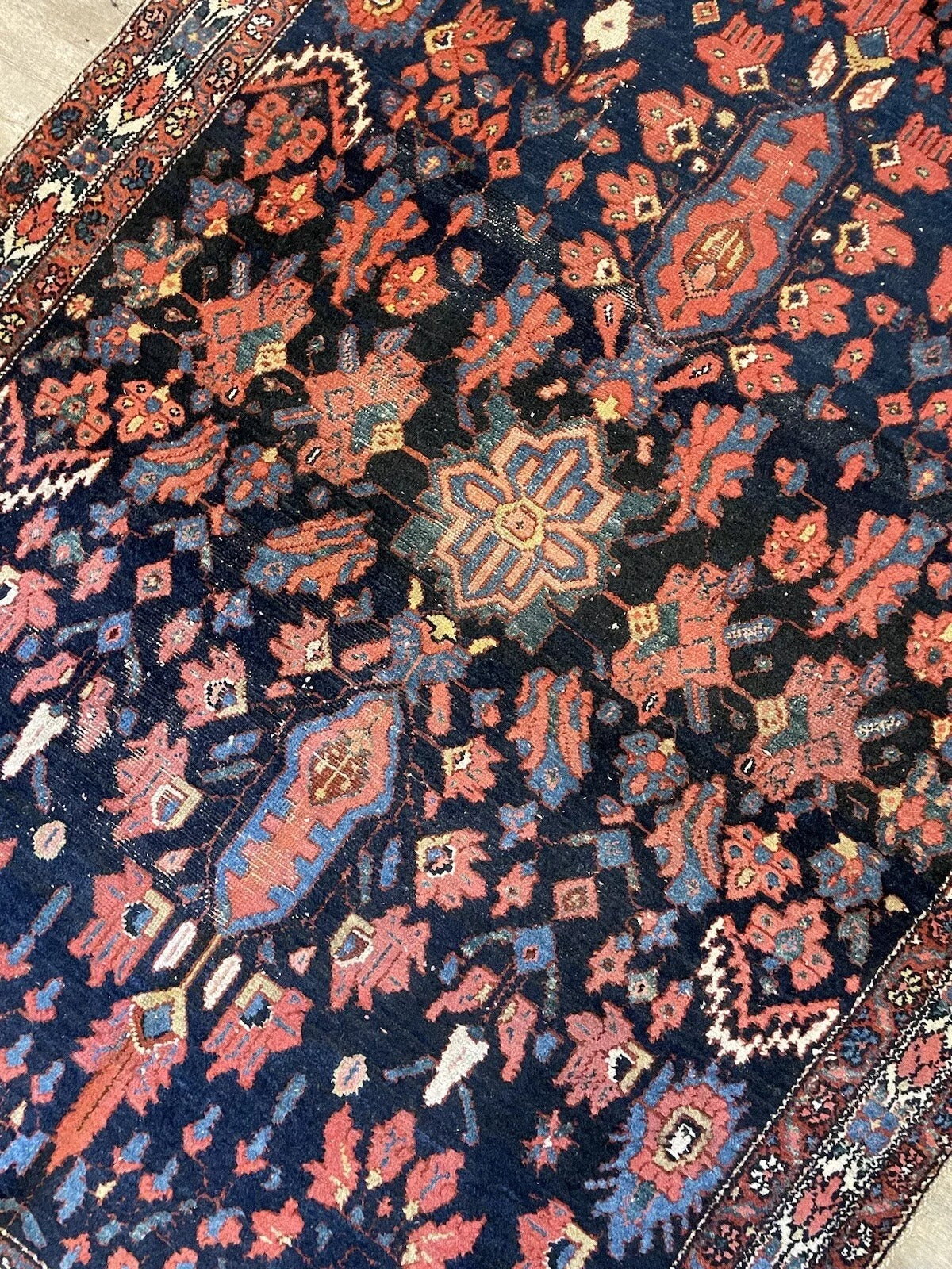 Intricate handwoven patterns on a vintage Bakhtiari wool rug
