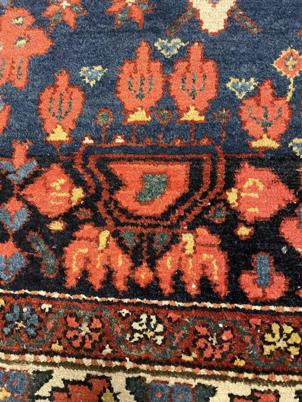 Detailed corner view of an antique Bakhtiari wool rug
