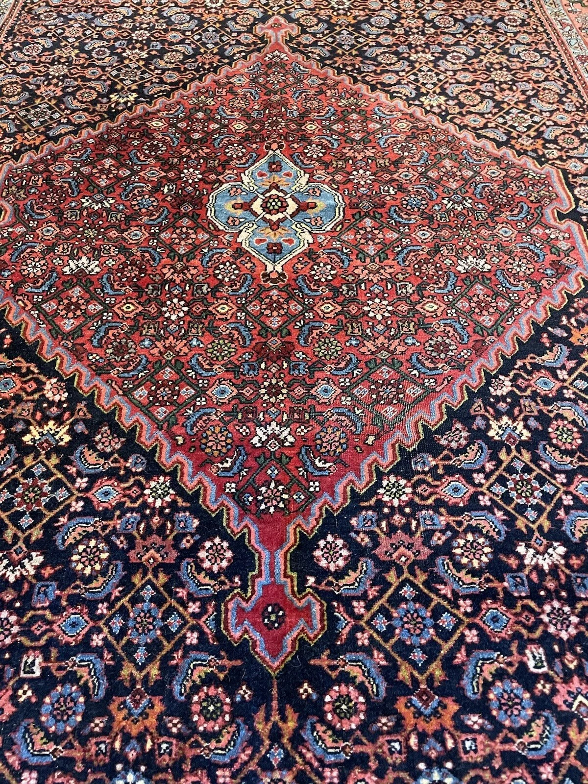 Floral and geometric details on a well-preserved Bidjar rug
