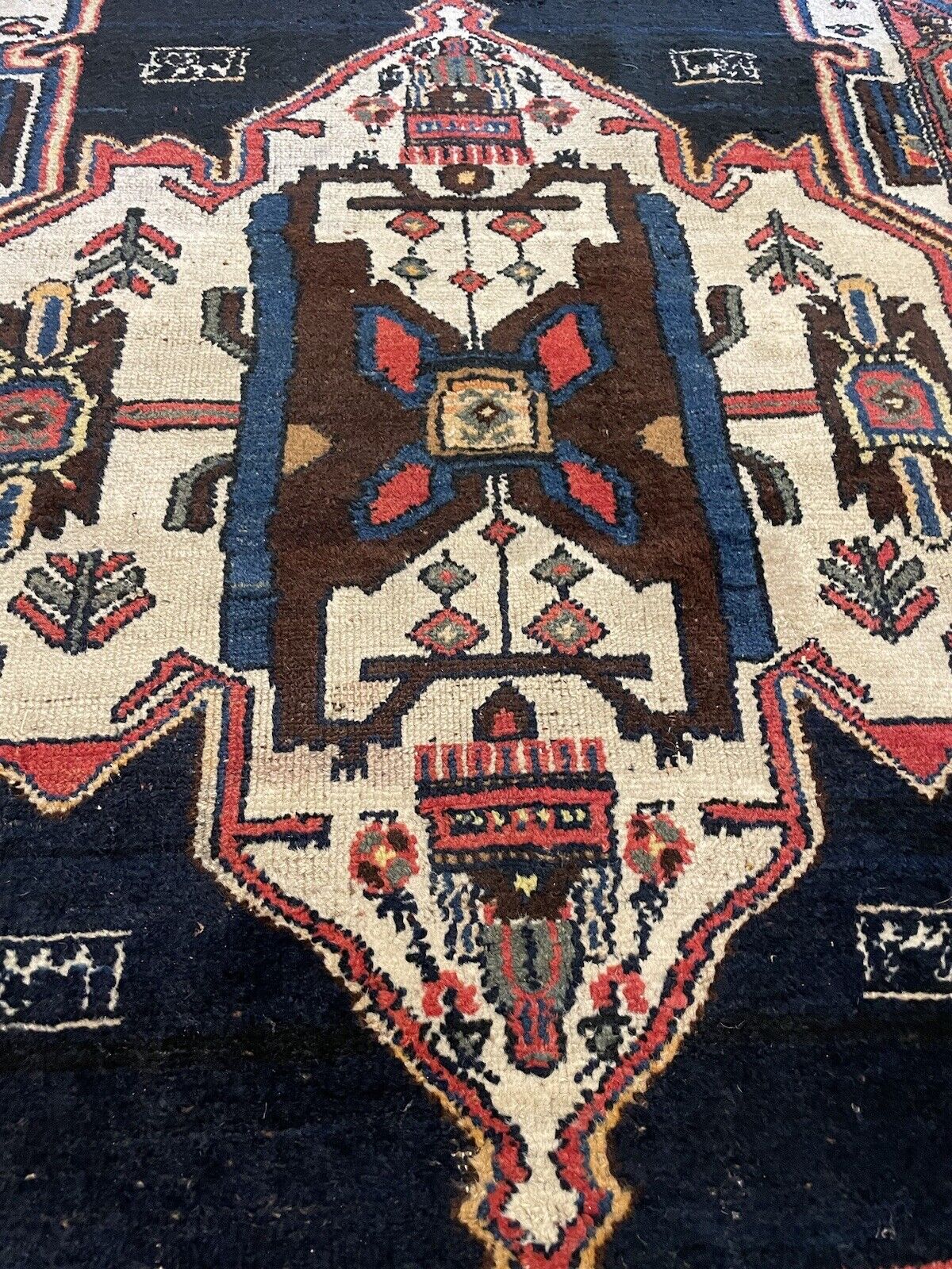 Long antique wool rug with vibrant geometric patterns
