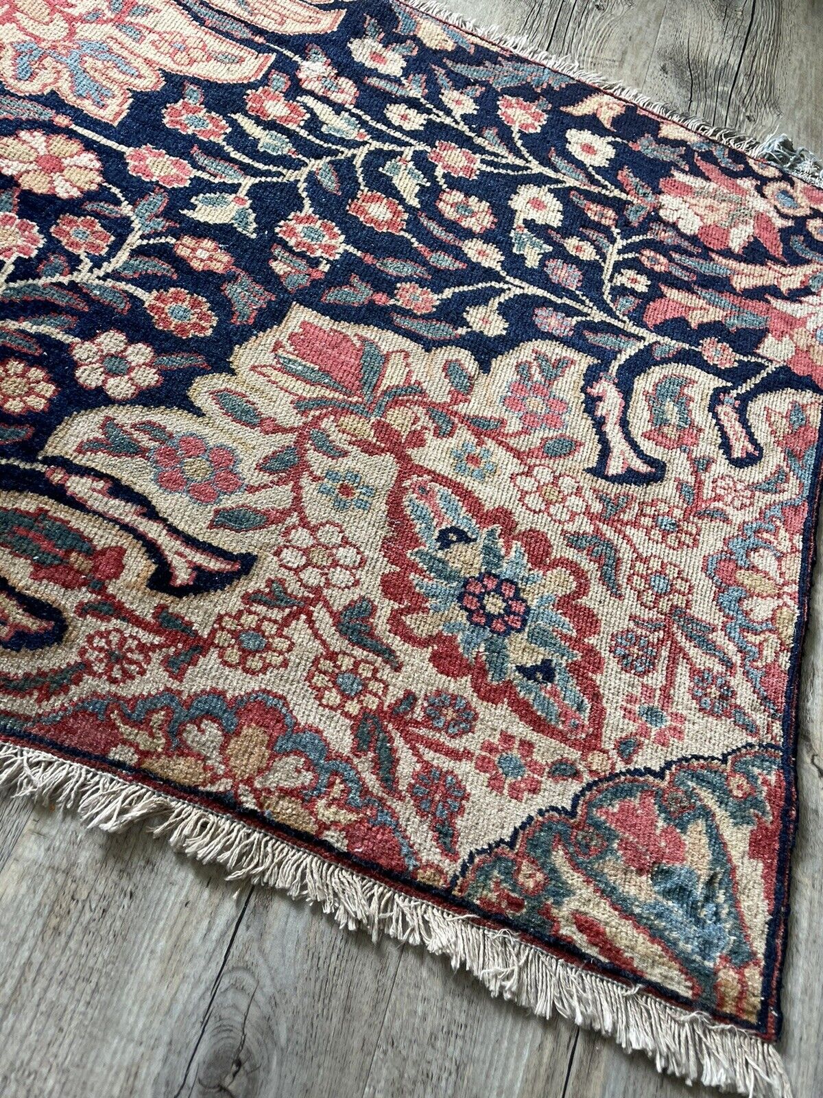 Aged but well-preserved handwoven rug with refined borders
